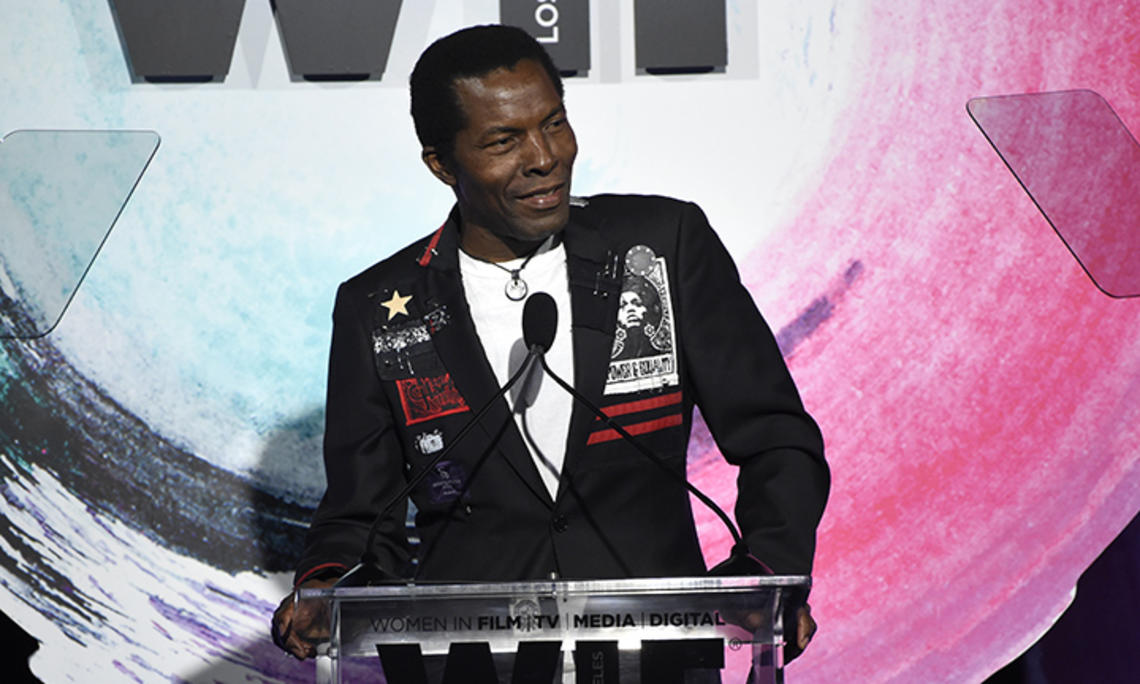 Actor Isaach De Bankolé speaks at a podium.
