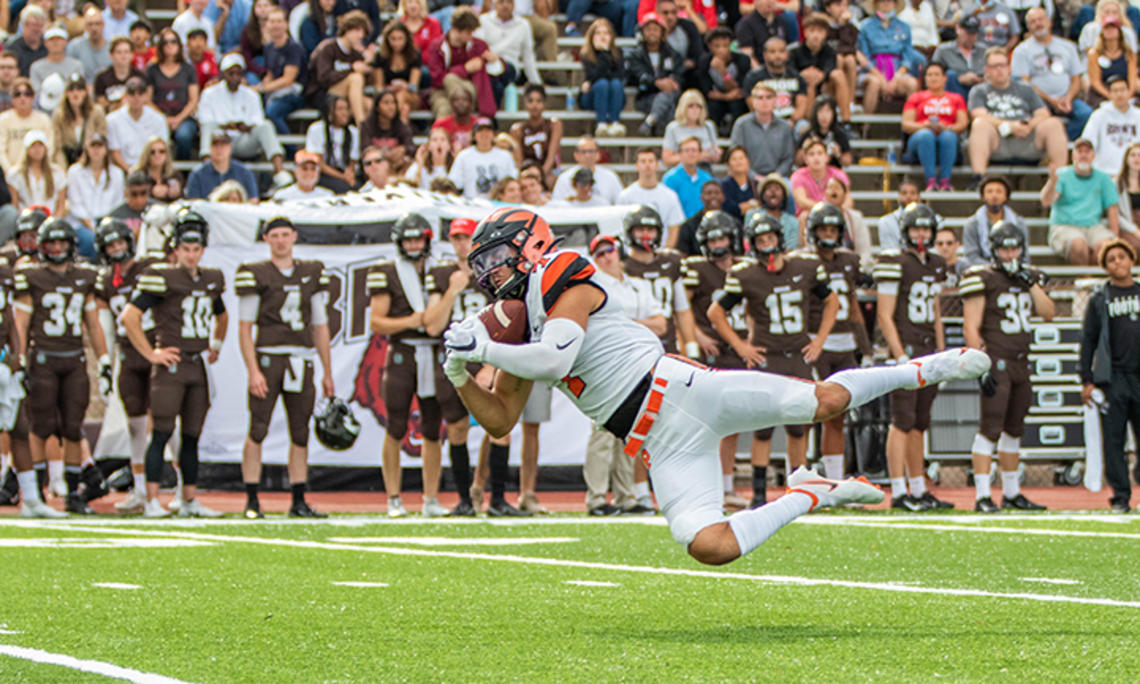 Wide receiver Dylan Classi ’23 dives sideways to catch the ball.