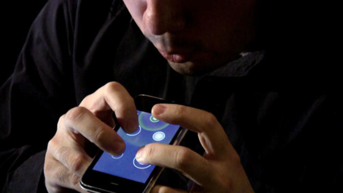 Ge Wang *08, below, created Ocarina, which can turn the iPhone into a flutelike instrument. Above, he demonstrates how it is played.