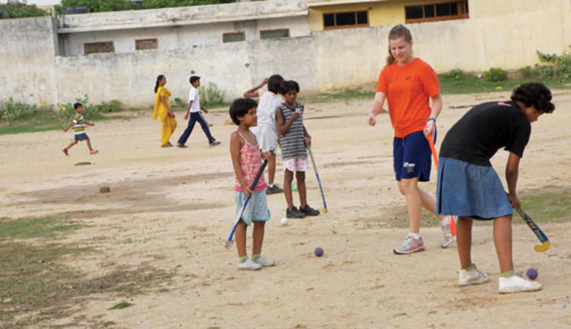 Allison Behringer ’12, a varsity field hockey player, introduced the sport to children at an orphanage in India where she taught during her summer 2010 internship. Below, Alex Banfich ’12 with French pupils at a July 4th celebration.