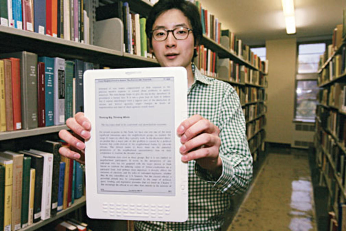 Brian No ’10 with the Kindle DX e-reader, which is being used by three Princeton classes in a pilot program this fall.