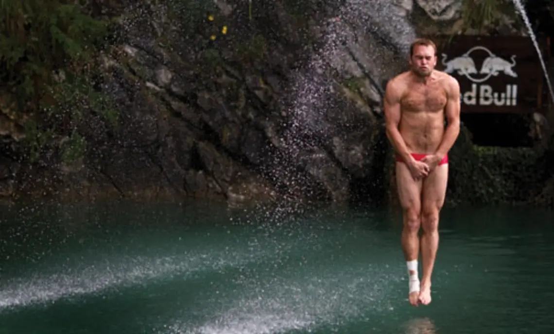 Kent DeMond ’07 braces himself before entering the water at the 2010 Red Bull Cliff Diving World Series in Sisikon, Switzerland, in August.
