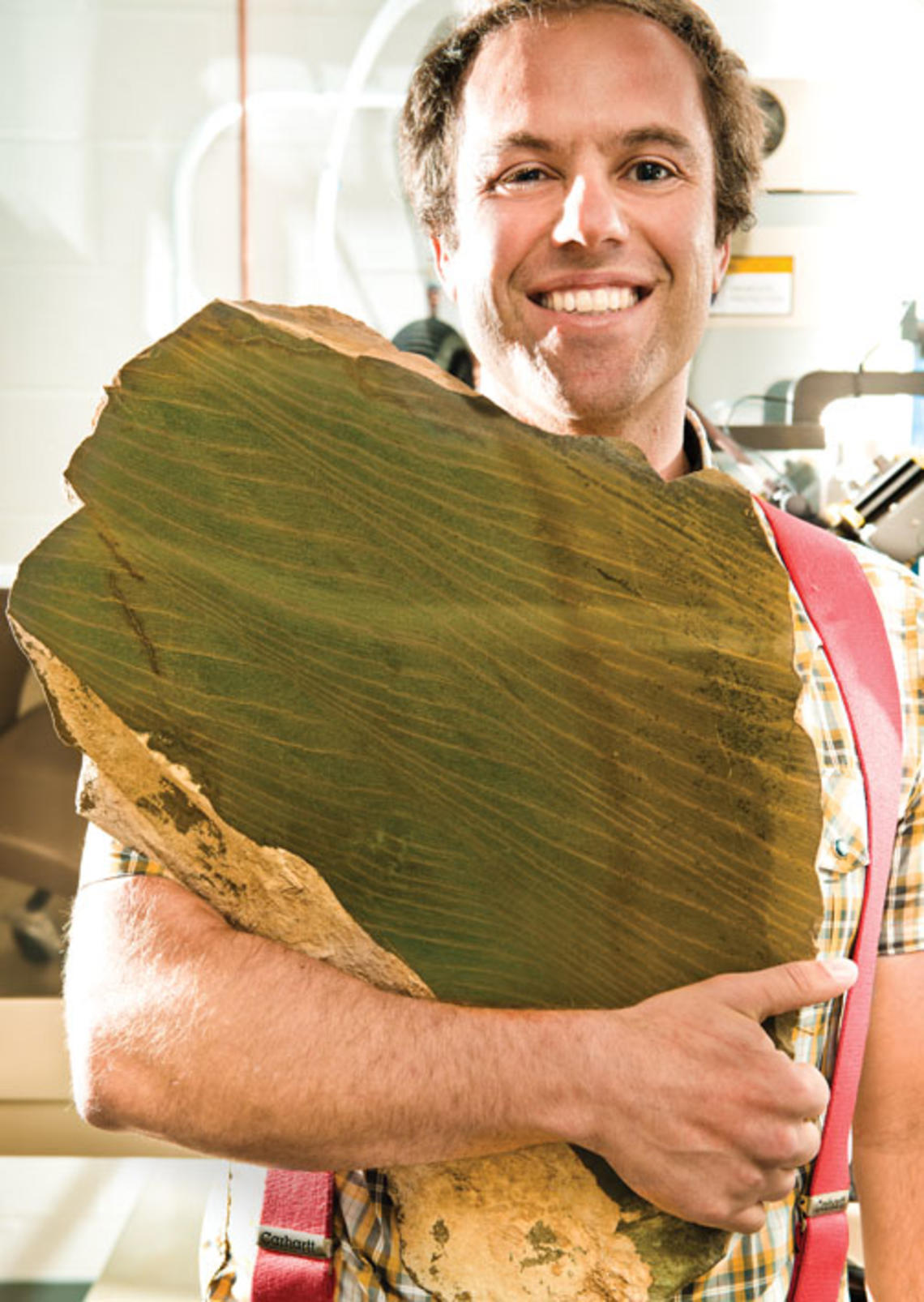 Adam Maloof prepares to grind a rock that records tidal cycles 640 million years ago.