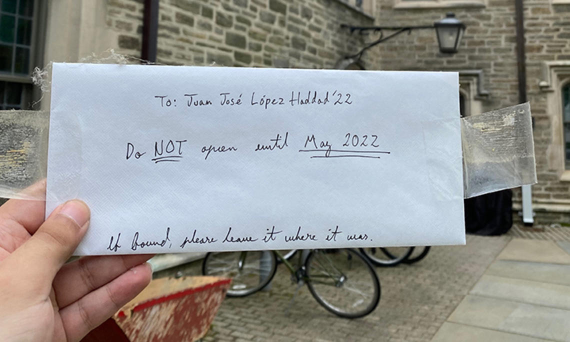 A hand holds the envelope Haddad left in his freshman room; it reads: To: Juan Jose López Haddad ’22, Do NOT open until May 2022. If found, please leave it where it was.