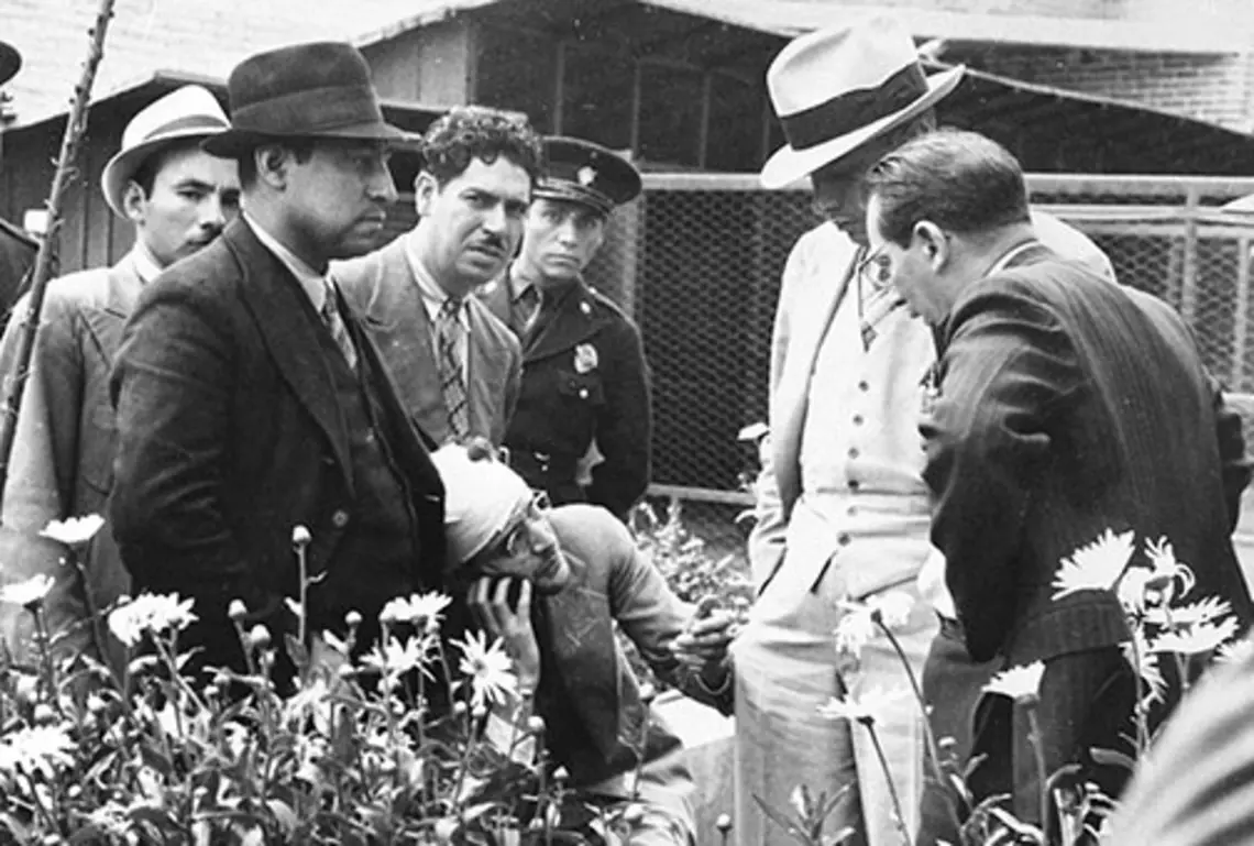 Ramón Mercader del Rio (in bandages), who murdered Marxist Leon Trostky, talks to investigators, in a photograph in Firestone Library’s Collection.