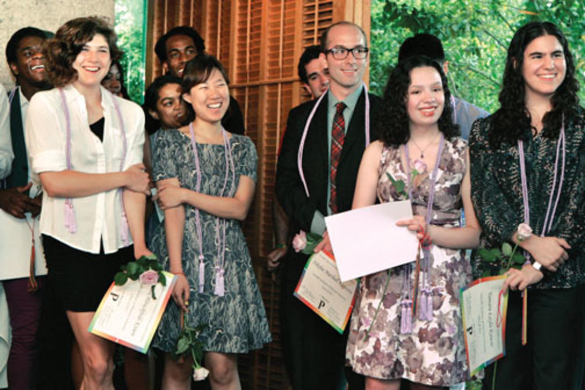 NB-OTC-LAVENDER5485new.jpg After receiving their lavender honor cords, rainbow tassels, certificates, and lavender roses during the LGBT Center’s Lavender Graduation at Prospect House, students smile at the comments of another member of the Class of ’13.