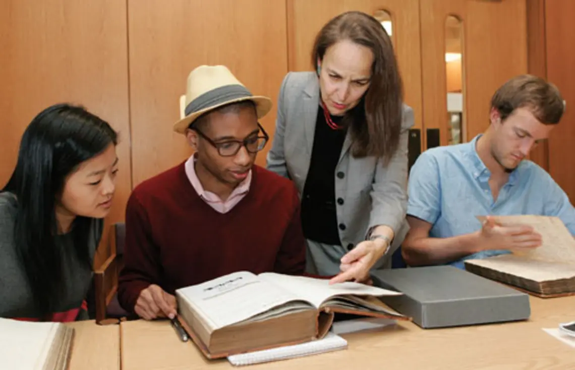 Reviewing 18th- and 19th-century faculty minutes in Mudd Library are, from left, Janie Lee ’15, Micheal Gunter ’14, Professor Martha Sandweiss, and Thatcher Foster ’14.