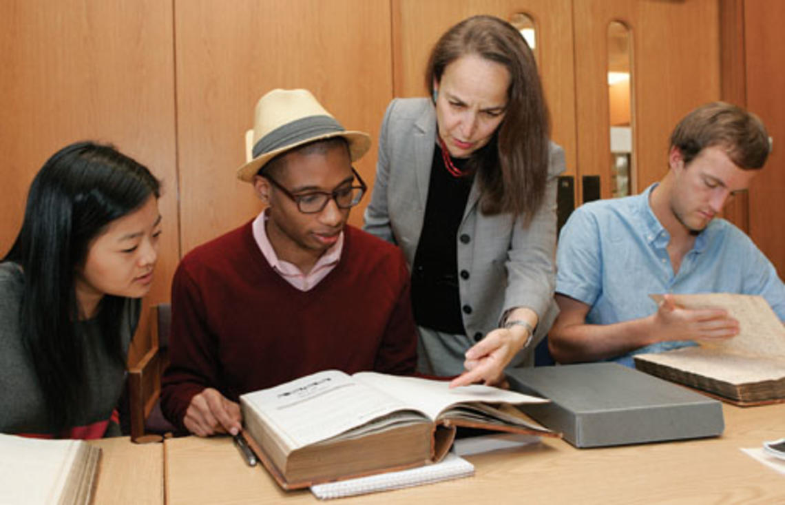 Reviewing 18th- and 19th-century faculty minutes in Mudd Library are, from left, Janie Lee ’15, Micheal Gunter ’14, Professor Martha Sandweiss, and Thatcher Foster ’14.