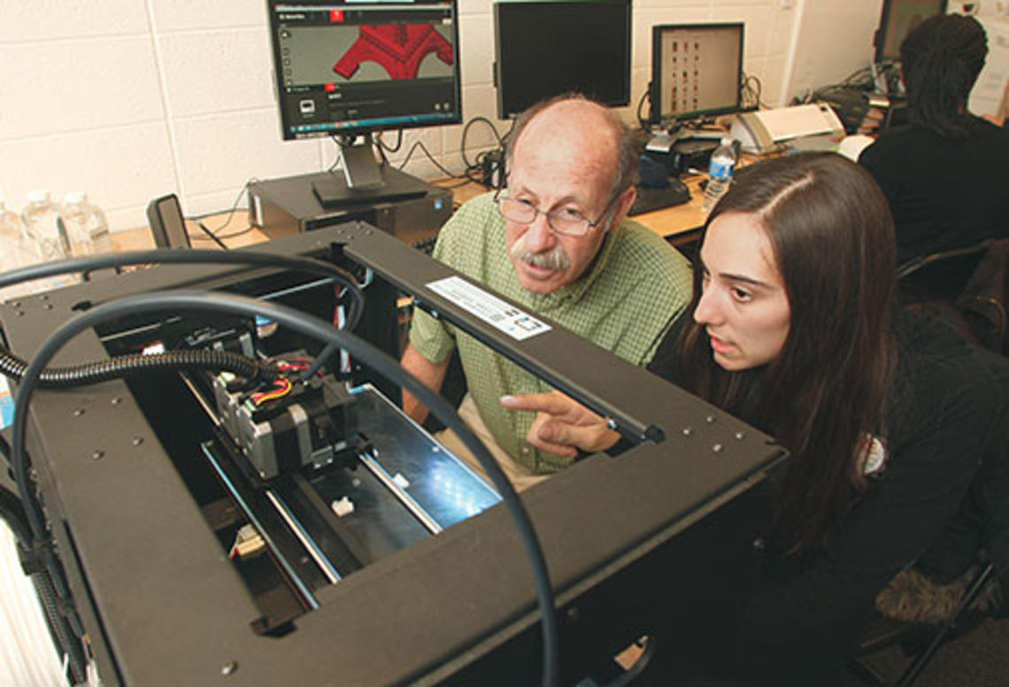 Professor Michael Littman and Cara de Freitas Bart ’15 review the results of a 3-D printing test.