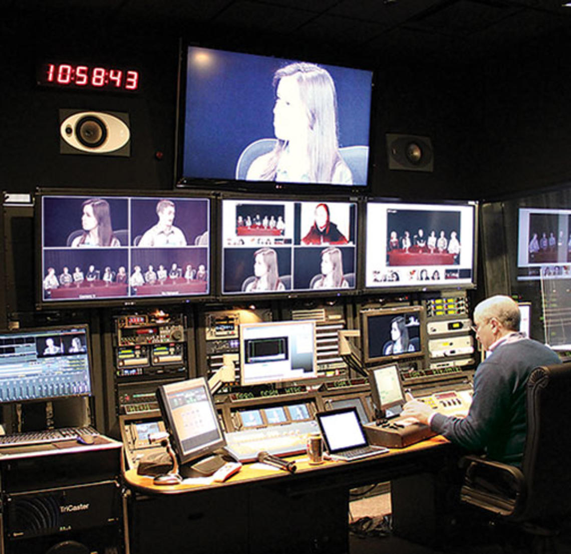 Students in an online course taught by Professor Jeremy Adelman are shown on screens at Princeton’s Broadcast Center as broadcast engineer Dan Kearns operates the console.