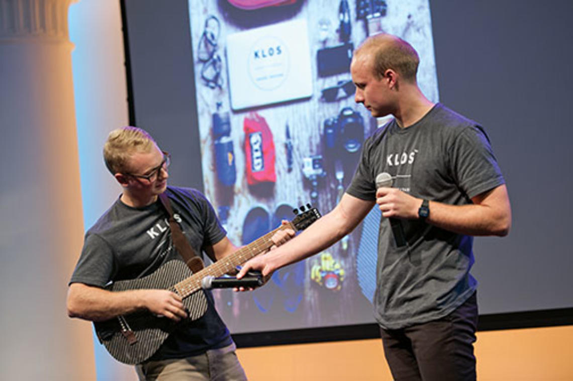 Adam Klosowiak ’15, left, demonstrates a KLOS travel guitar with Jake Sheffield, also of KLOS.