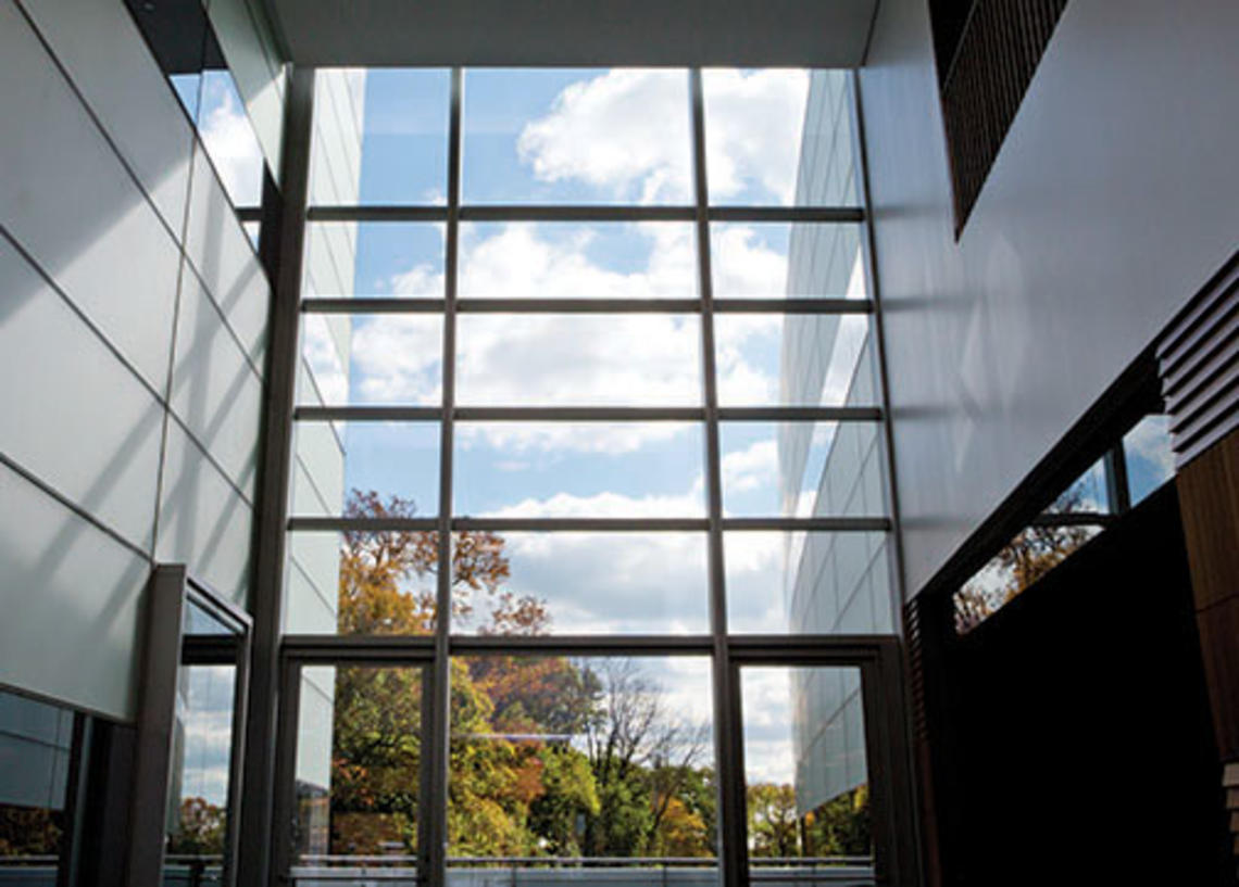 The view south from the two-story atrium of the neuroscience/psychology building; an outdoor patio is beyond the glass wall.