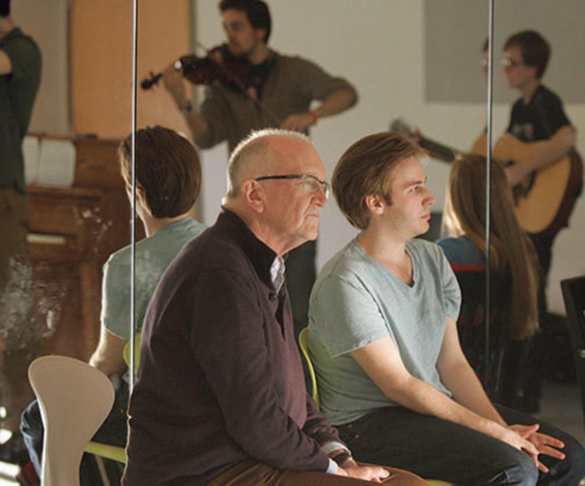 Director John Doyle and Christopher Beard ’14 watch student actor-musicians perform.