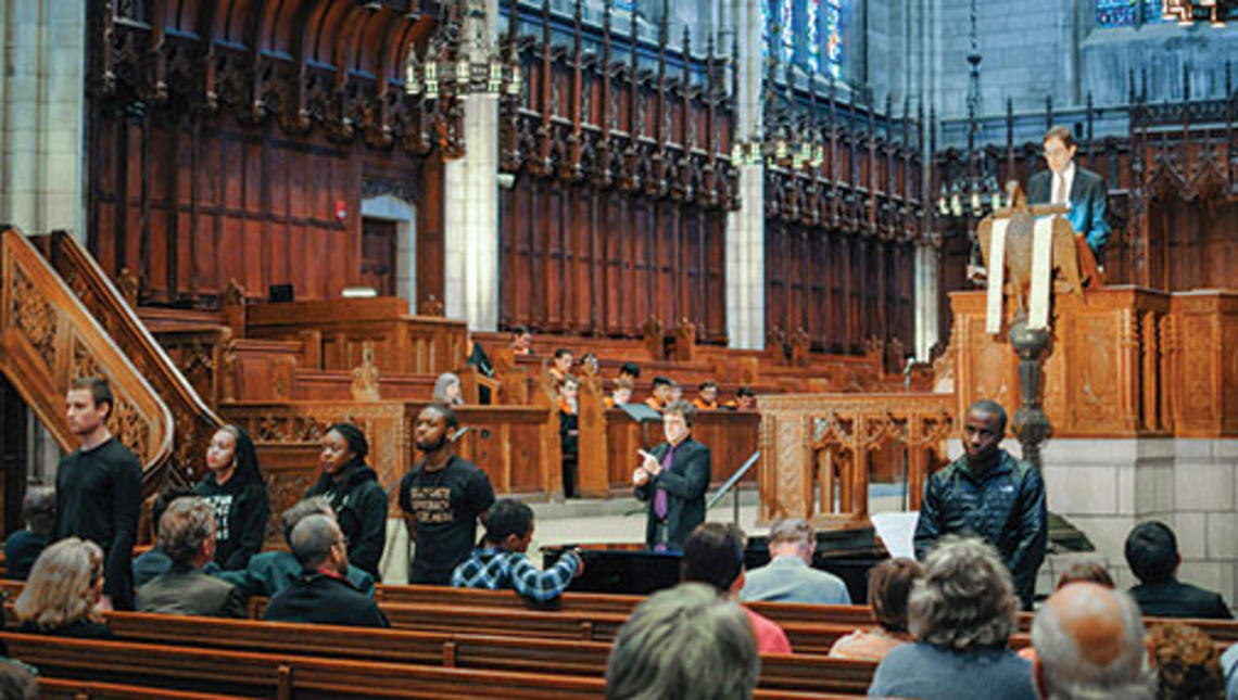 Students turn their backs to President Eisgruber ’83 as he speaks in the Chapel April 12.