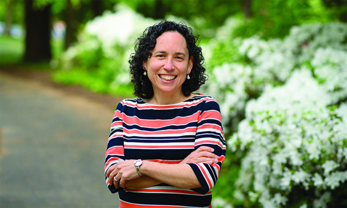 OTC_Rabbi Julie.jpg This is a photo of Rabbi Julie Roth outdoors, with green shrubs in the background.