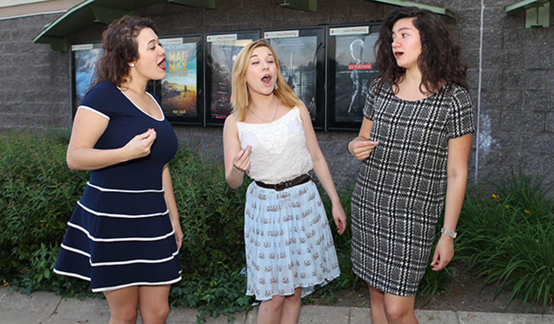 From left, Wildcats a cappella members Kat Giordano â18, Arianna Lanz â17, and Samone Blair â18 review Pitch Perfect 2 with PAW senior writer Mark F. Bernstein â83. (Beverly Schaefer)