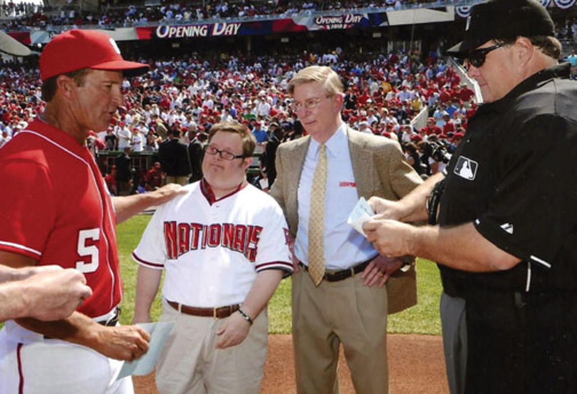 Baseball fan Jon Will, pictured with his father, gives the Washington Nationals’ lineup card to umpires on Opening Day in 2010.