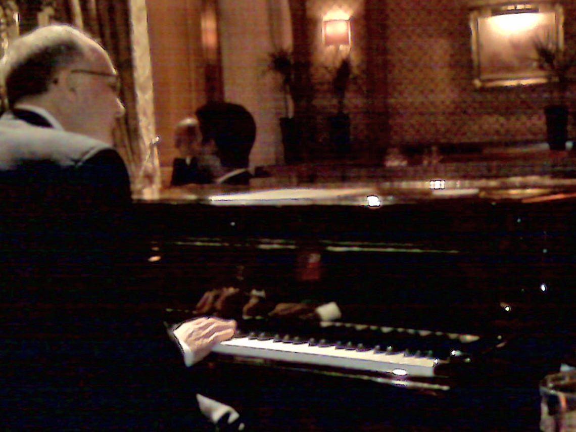 A cellphone photo captures Thomas Schiavoni ’72’s moment at the Steinway of the Bar Vendome in the Hotel Ritz in Paris. 