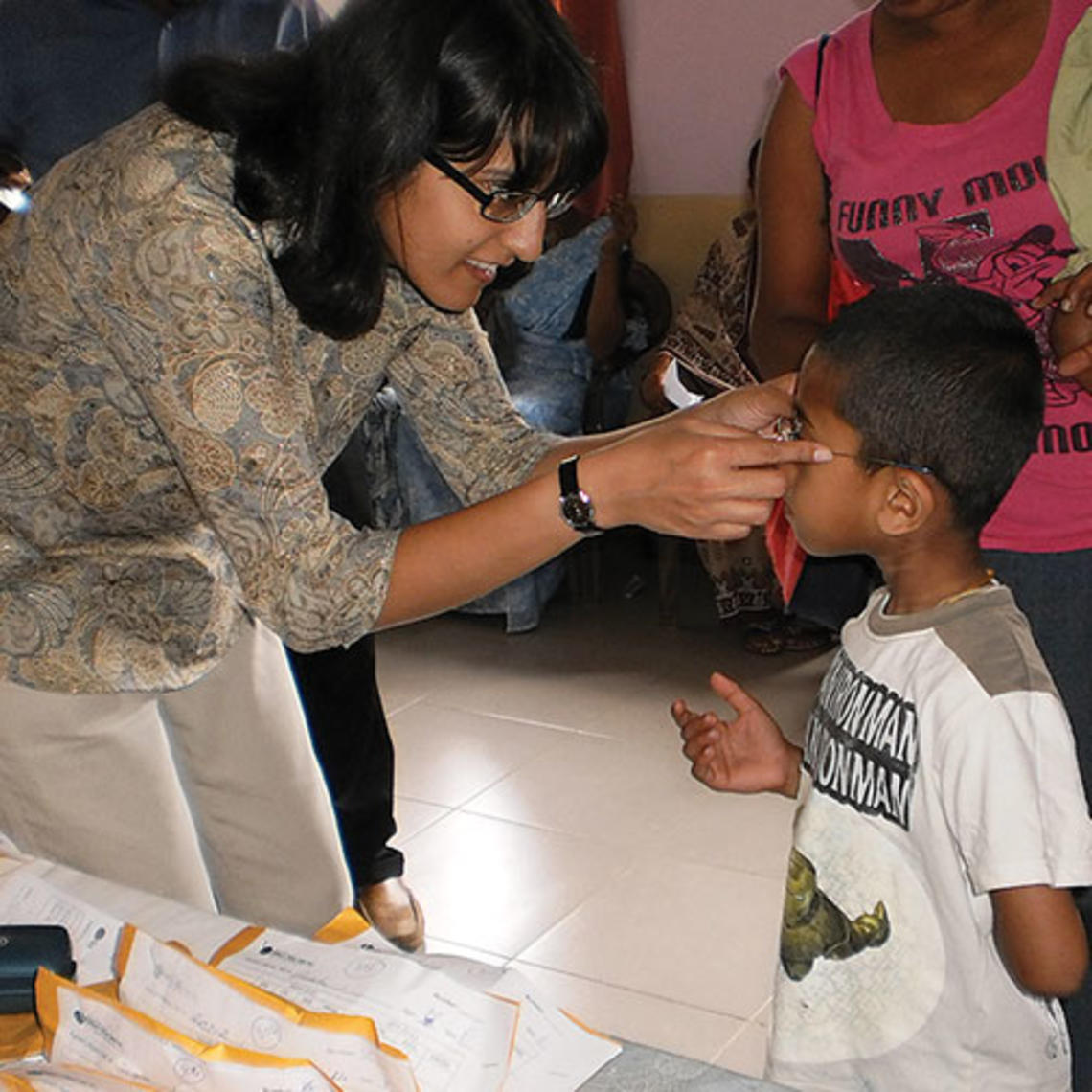 A nonprofit founded by Ashanthi Pereira Mathai ’95, left, has provided prescription eyeglasses to 35,000 children and adults.