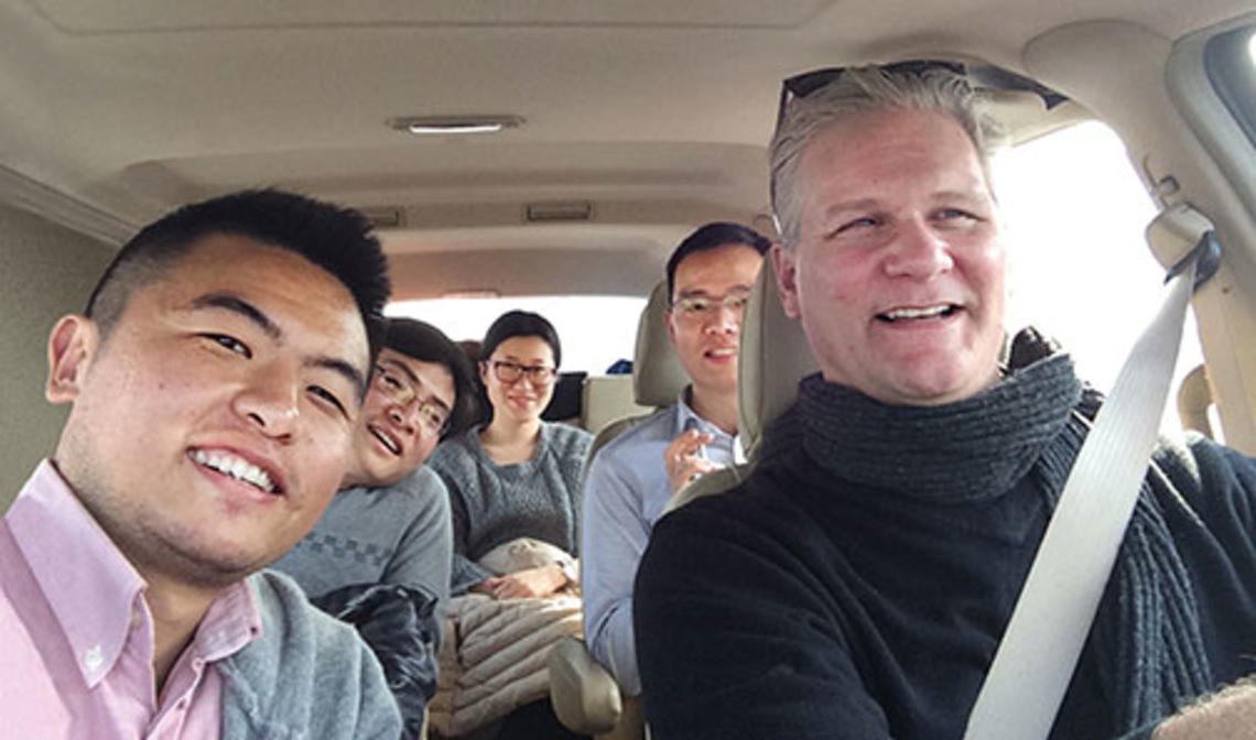 Frank Langfitt ’86 with his NPR assistant, Yang Zhuo (left), and passengers in the “Free Loving-Heart Taxi”