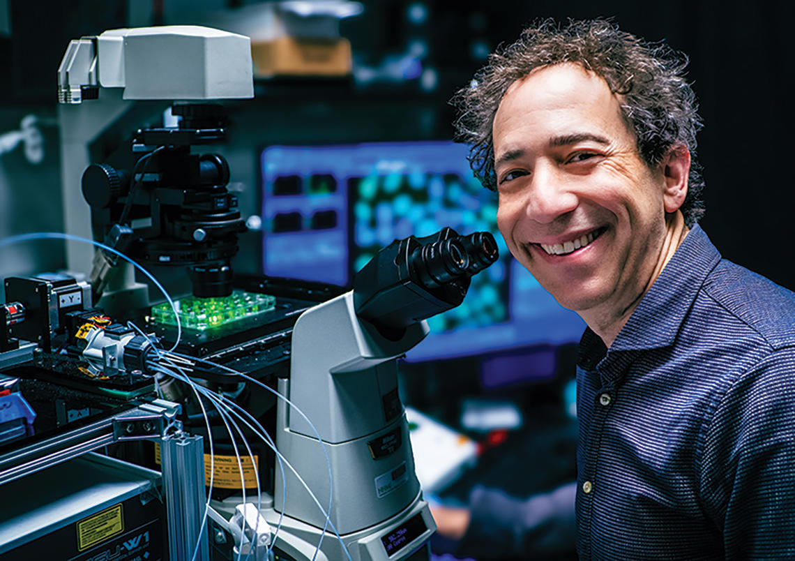 RESEARCH_Michael Elowitz.jpg Michael B. Elowitz *99 with a microscope.