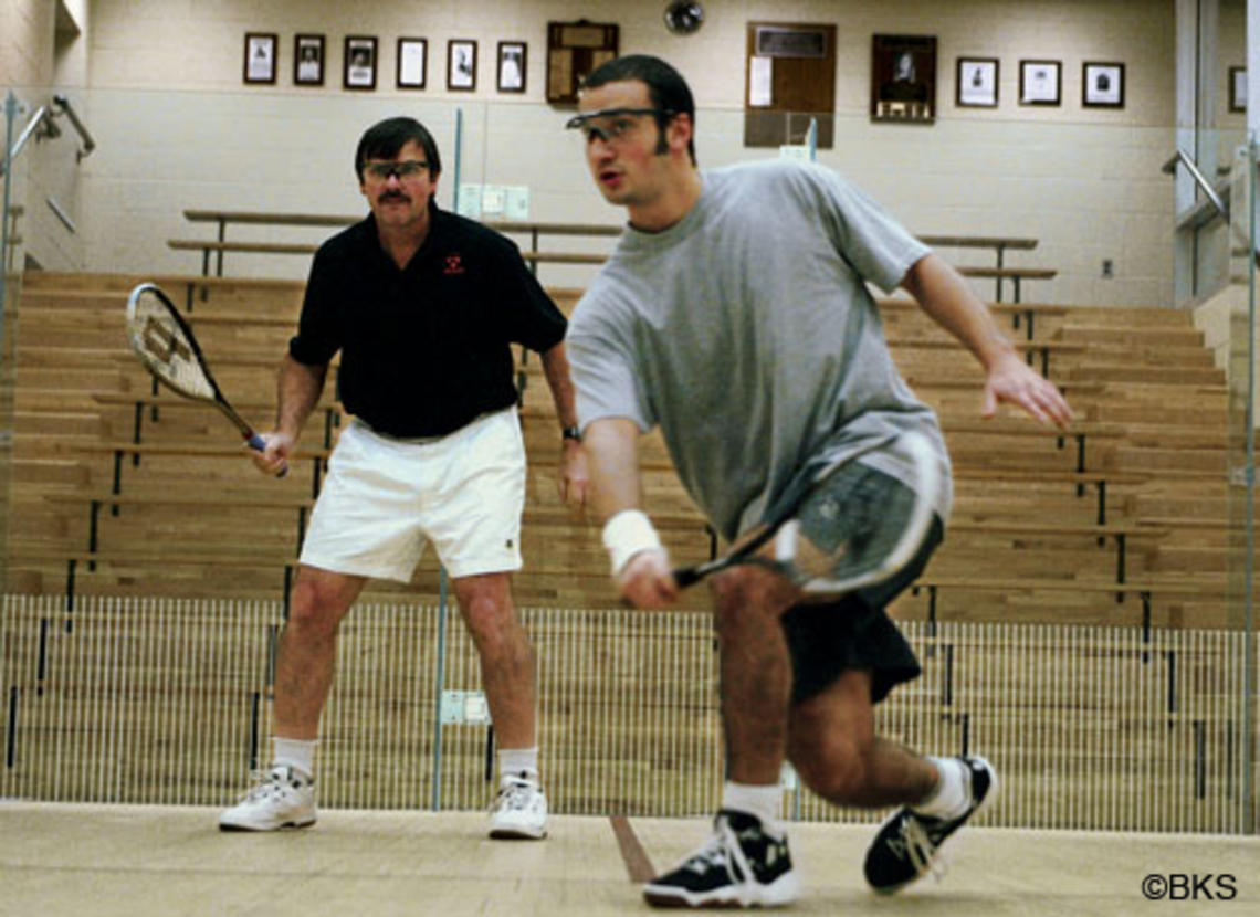 Men’s squash coach Bob Callahan ’77 retired in April after 32 seasons at Princeton. In 2005, Callahan, left, scrimmaged with top player Yasser El Halaby ’06.