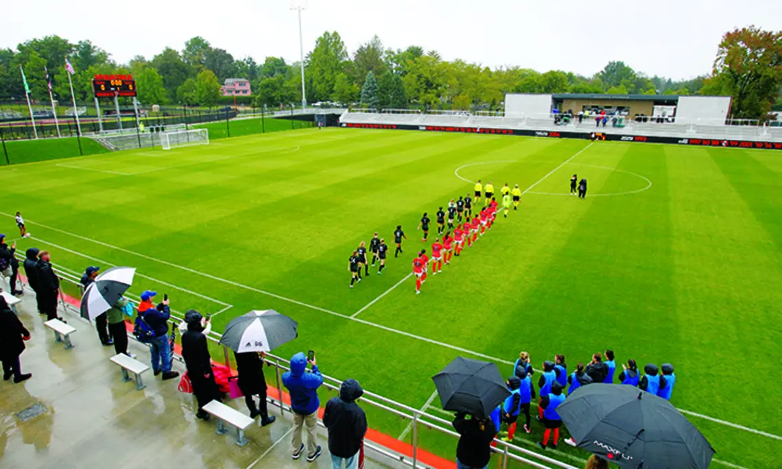 SPORTS_Myslik Stadium 1.jpg Women’s soccer players walk onto the field in two lines before the start of the game.