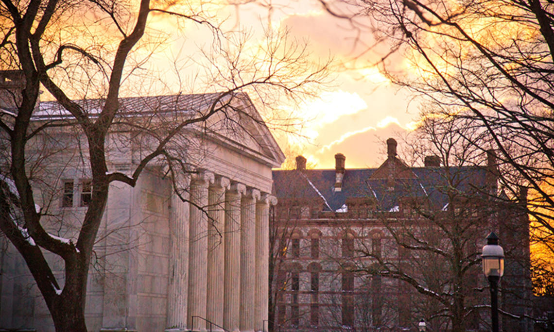 The sun rises over Princeton University campus buildings in 2014.