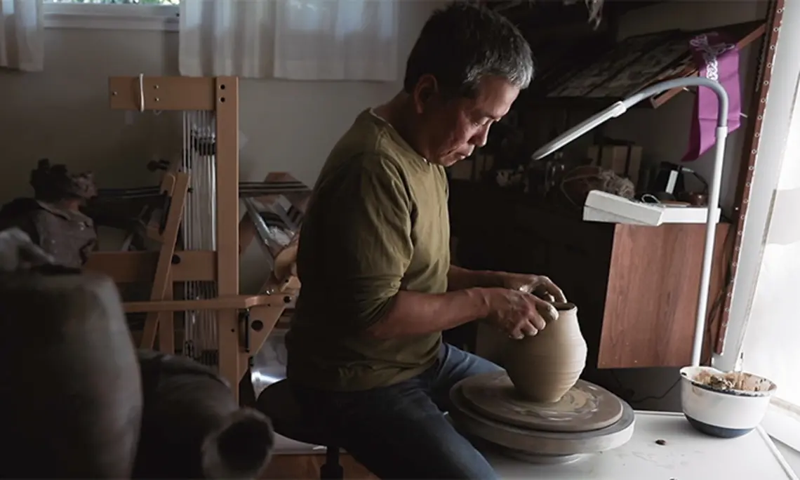 TOW_HideoMabuchi.jpg Hideo Mabuchi makes a vase on his pottery wheel.