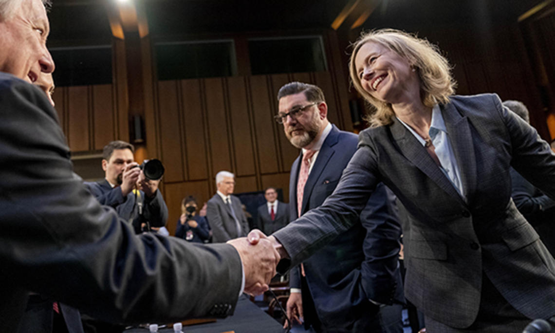 Kathleen Bradish ’94 shakes hands with Chairman Sen. Dick Durbin, D-Ill. at a Senate Judiciary Committee hearing to examine promoting competition and protecting consumers in live entertainment on Capitol Hill in Washington, in January 2023.