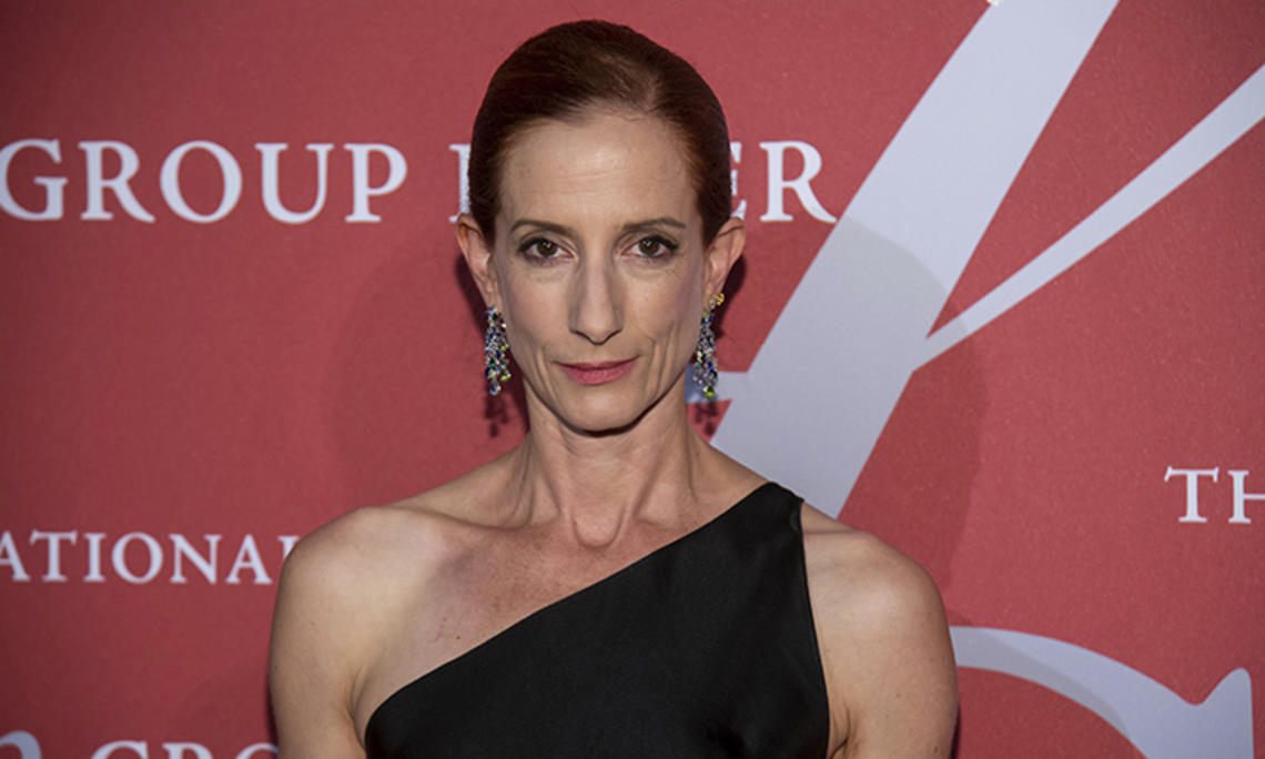 A headshot photo of Vanessa Friedman ’89 in front of a step and repeat at a gala event.