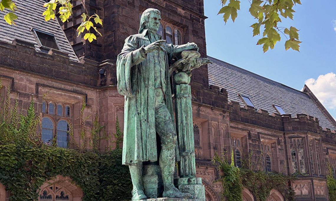 Princeton’s statue of John Witherspoon, turning green outdoors.