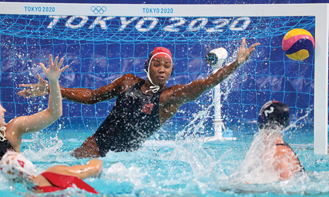 Ashleigh Johnson leaps to her left to save a shot