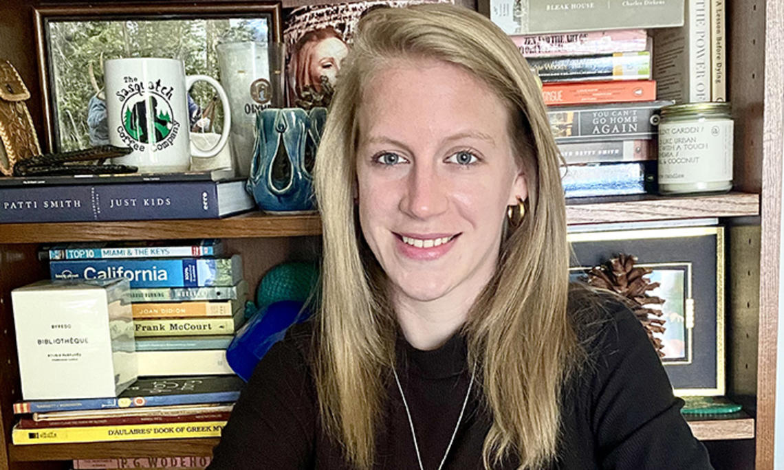 This is a photo of Jessica Welsh ’14 with a bookcase in the background.