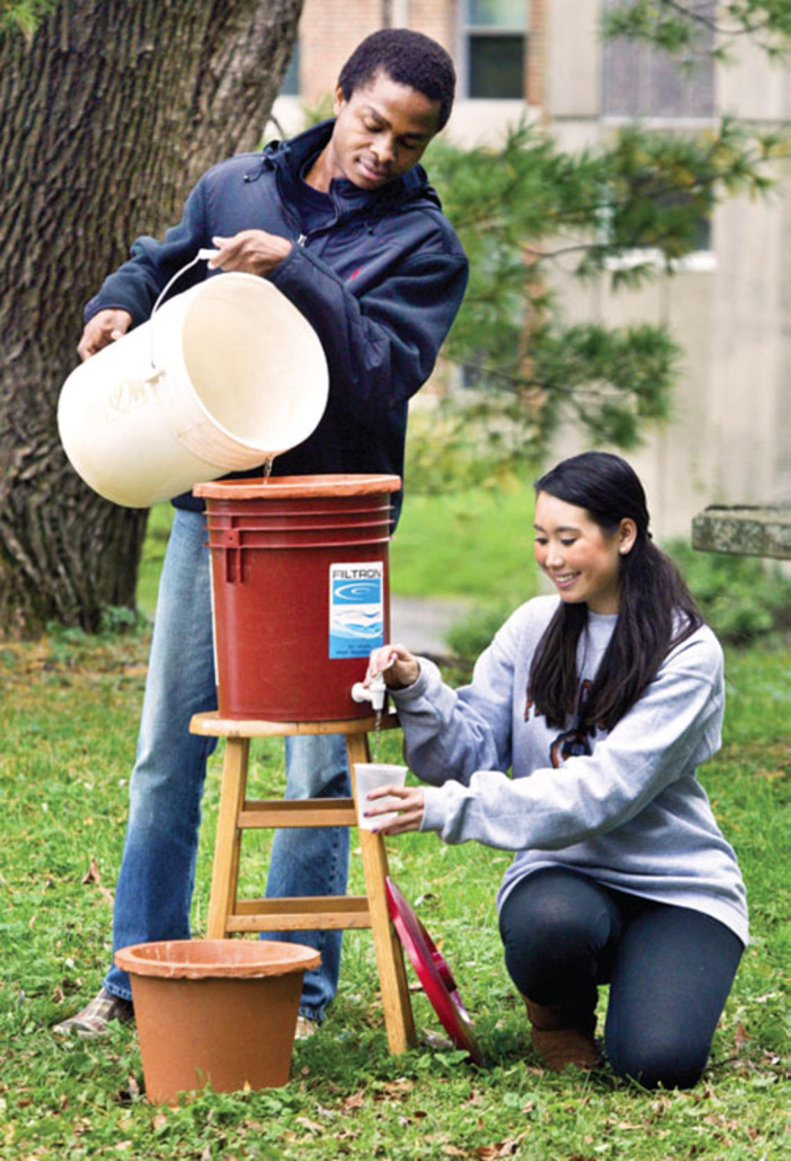 Mechanical and aerospace engineering graduate student Ismaiel Yakub and civil and environmental engineering major Megan Partridge ’14 join forces to demonstrate a ceramic filter system that promises to remove pathogenic bacteria from African drinking wa