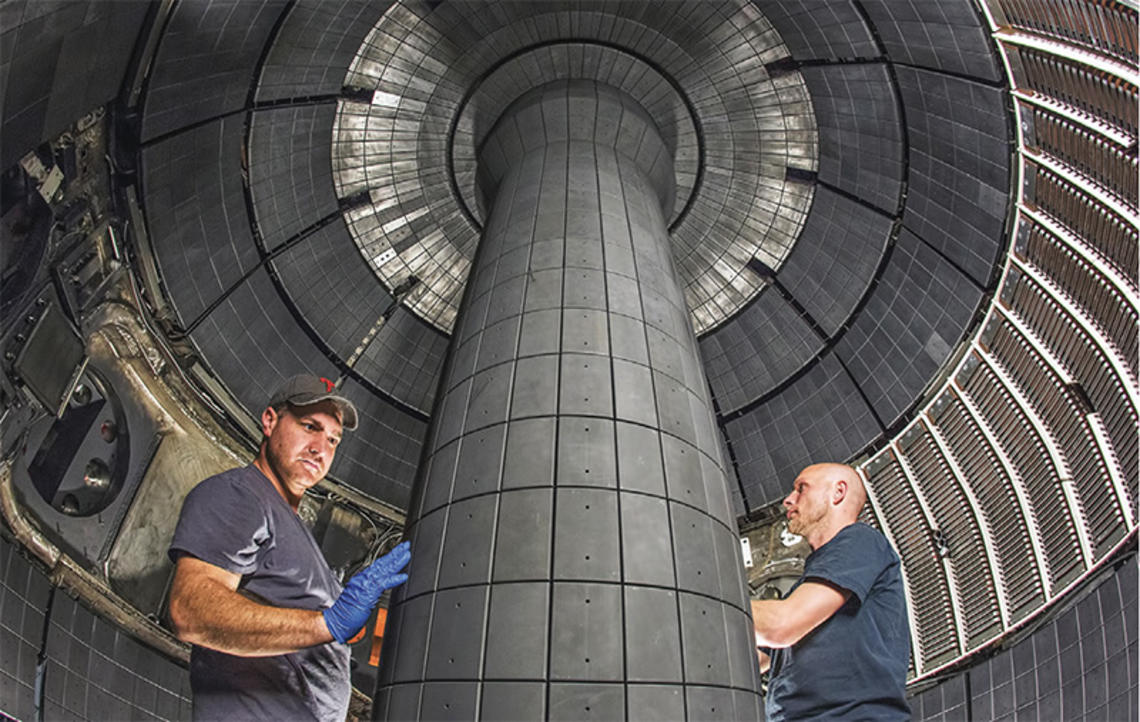 Technicians working inside a fusion device