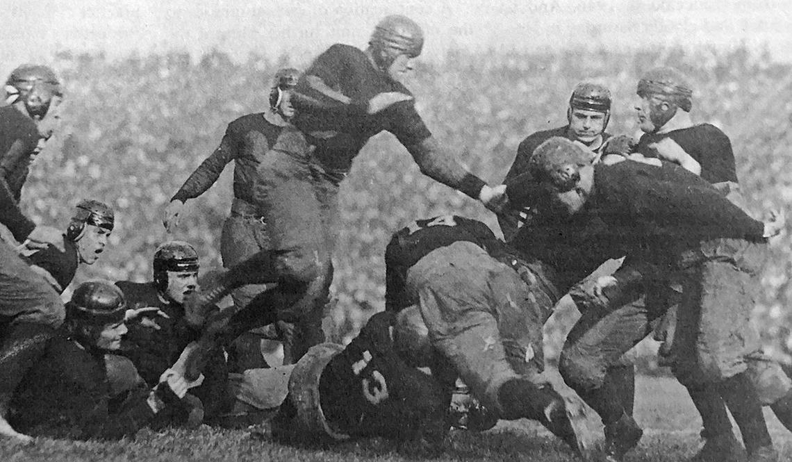 This is a black-and-white photo of a football tackle from 1922.