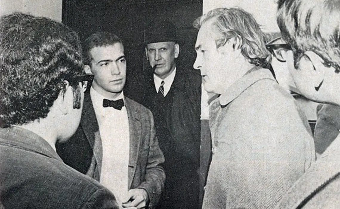 Proctor âAxelâ Peterson, with pipe, looks on as students interview Dr. Timothy Leary. (George Peterson â69/PAW Archives)