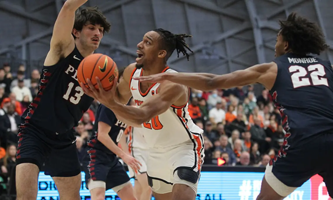 tosan-penn.jpg Princeton player Tosan Evbuomwan scoops left-handed shot between two defenders