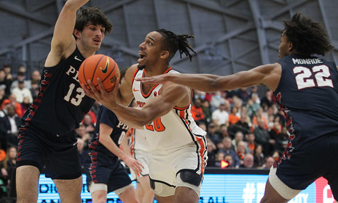 Princeton player Tosan Evbuomwan scoops left-handed shot between two defenders