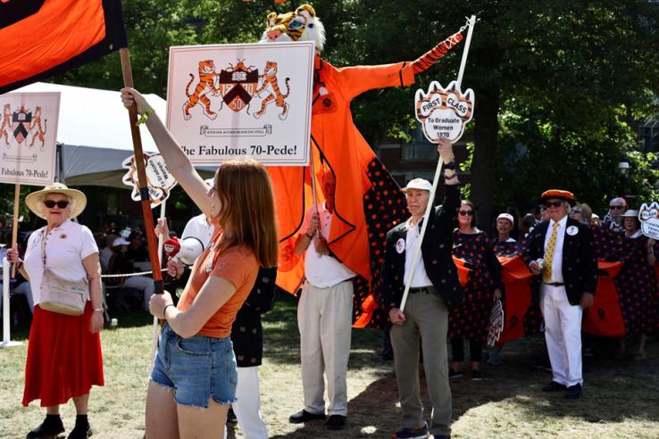 People march in the P-rade holding signs that read "The Fabulous 70-Pede!"