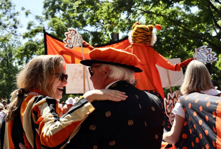 People march in the P-rade with a tall tiger.