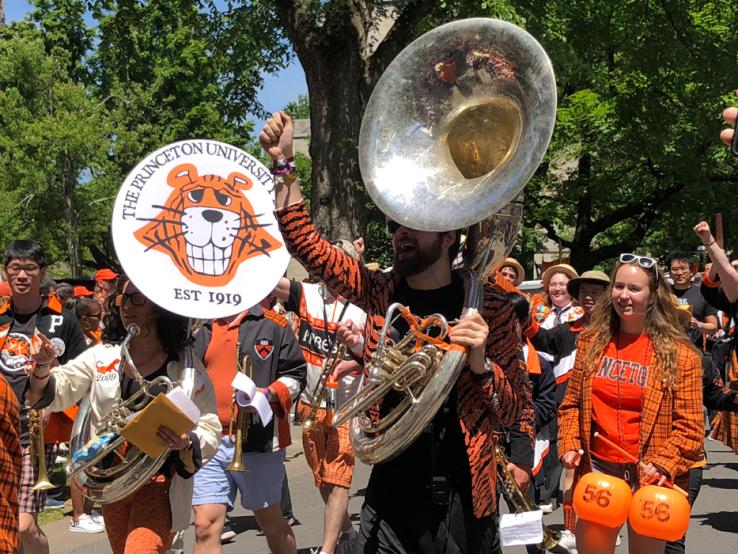 Band members march in the P-rade; one holds a tuba. 