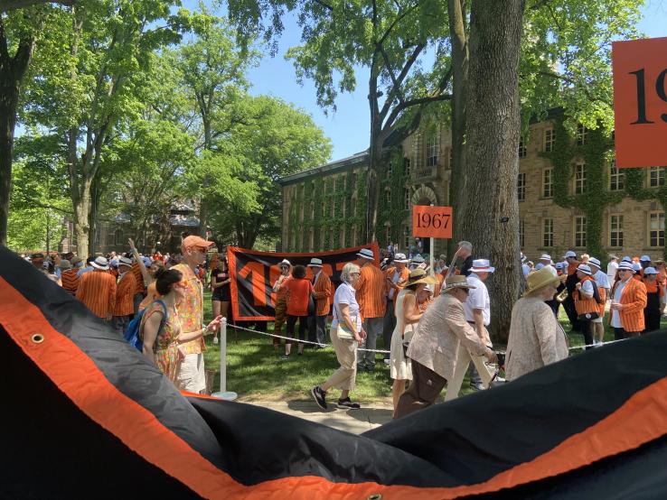 The Class of 1967 and others hold their orange class banners in front of Nassau Hall, getting ready for the P-rade.