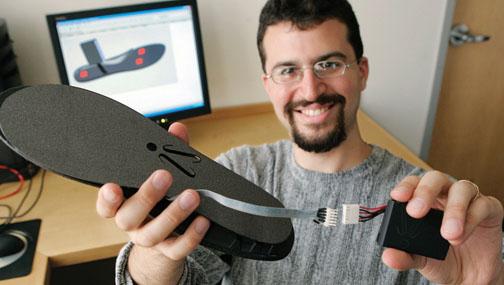 In this 2008 photo, Aiden displays the shoe insole he developed to detect when a wearer is losing balance.