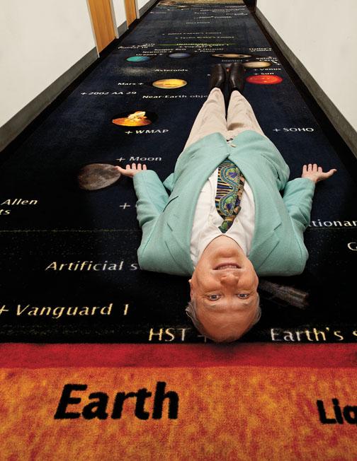 J. Richard Gott *73 on his “astronomical carpet.” The map on the carpet appears in the forthcoming book, “Sizing Up the Universe: The Cosmos in Perspective,” co-authored by Gott and Professor Robert Vanderbei.