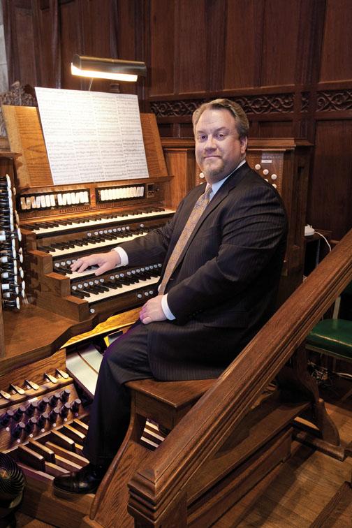 Even when the Chapel is full, playing the organ is a “very solitary” experience, says organist Eric Plutz, above. In the Chapel, Plutz sits up front, beneath the chandelier. “People don’t know I’m up there. I feel a little bit like the Wizard of