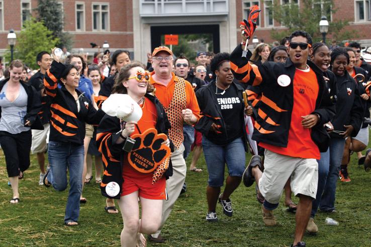 Members of the Class of 2008, including Gabriel Ivey (front, right), along with one member of '69 — Eric T. Johnson, father of Ashley Johnson '08 (front, left) — make their alumni debut on Poe Field with enthusiasm.