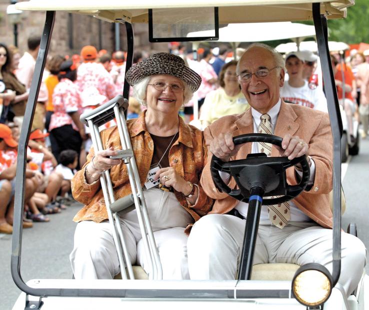 James Donnell '53 and his wife, Sally, enjoy the crowd's cheers as they ride in the P-rade.