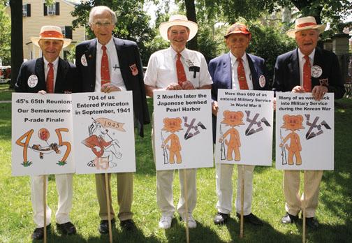  Class historians: From left, Ed Simsarian, Bill Hagendorn, Al Behrer, Jim Calvert, and Chet Files hold signs that recount some of ’45’s milestones.